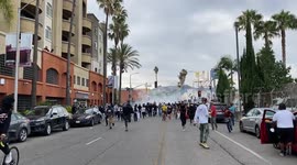 Scared George Floyd Protestors near Erewan Grocery store in Los Angeles run away from the police and national guard after snipers fired at them from Jewish Synague rooftoops