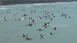 Swathes of surfers hit the waves on French public holiday