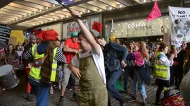 Extinction Rebellion climate protest march through Manchester, uk, with drummers and dancing