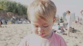Cute Baby Girl Tries to Put on Her Mummy’s Sunglasses on the Beach