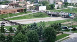 Police fire tear gas and flash bang at crowd over bridge.