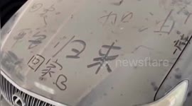 Encouraging messages written on dusty car left in garage during COVID-19 lockdown