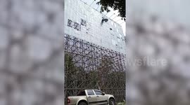 Metal sheet blows down from building during storm in Thailand
