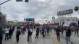 Los Angeles Fire Fighters drive near CBS Studio to put out a police car on fire as protestors continue their rally in front of police