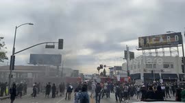 Los Angeles Fire Fighters Come close to CBS Studio to put out a police car on fire as protestors continue their rally in front of armed police