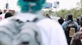Angry mob of Los Angeles George Floyd protestors chase after red sports car that tries to run them over and then run away from police who shoot at them