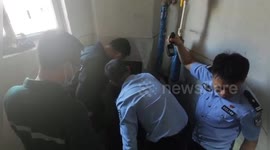Chinese firefighters rescue infant trapped in rubbish chute in residential building