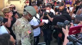 National Guard soldier prays and hugs protesters at Minnesota rally