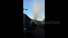 Helicopter drops water on wildfires in Rhondda Valley, South Wales