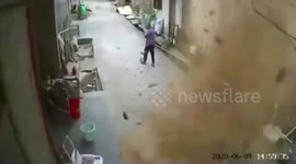 Elderly Chinese woman narrowly escapes injury after building roof collapses