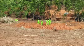 Workers wearing protective equipment seen burying COVID-19 victims in Indonesia