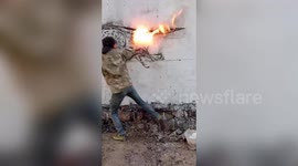 Creative Chinese man uses flaming wooden stick to draw on wall