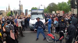 BLACK GUY stops protesters blocking police van