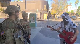 Comedian in cow costume cracks up National Guard on Hollywood Boulevard in Los Angeles
