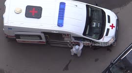 Ambulance and doctors in special costumes arrive to one of the cort yards in St. Petersburg, Russia