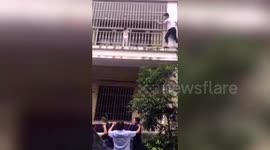 Chinese neighbour climbs two floors barehanded to rescue toddler trapped outside balcony