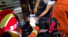 Firefighters in China free girl whose leg was stuck in revolving doors