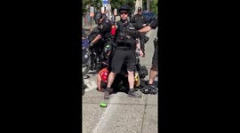 'Get off her!' Seattle police takedown protester at peaceful rally