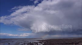 Epic spaceship like storm cloud with rainbow underneath in Kent, UK