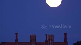Spectacular 'strawberry' full moon rises over historic UK church