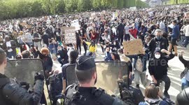 Protesters on their knees,rising fist, facing the Police in Homage to George Floyd, Sabri, and unauthorised protest against the police violence. Eiffel Tower, Champs de Mars.Paris.6june2020.17h