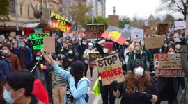 Protestors hold signs at Black Lives Matter protest, Melbourne
