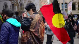 Woman flies aboriginal flag at Black Lives Matter protest, Melbourne