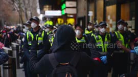 BLM protestor in gloves holds his hands up to police, Melbourne