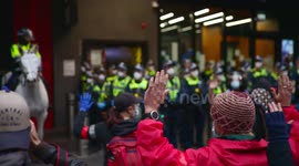 BLM protestors hold up their hands to police guarding police station, Melbourne