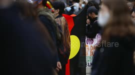BLM protestor holds aboriginal flag, Melbourne