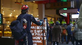 Indigenous man in costume during BLM protest, Melbourne