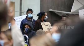Young BLM protestors hold signs, Melbourne