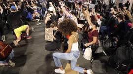 New York: Protesters defy curfew to march and kneel at police brutality demonstration