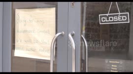 Closed restaurant with handwritten message during COVID-19 pandemic, small business, unemployment, recession, lockdown