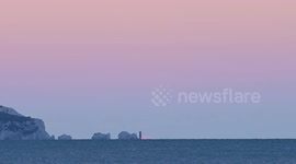Strawberry full moon rise behind the Needles Isle of Wight