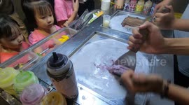 Street vendor makes ice cream rolls in Hue, Vietnam
