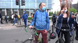 Banner claiming COVID 19 pandemic is racist chemical warfare against black people opposite the US Embassy at BLM protest in London