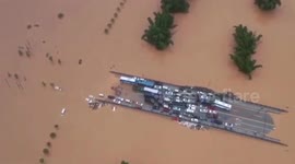 Dozens of vehicles park on bridge to avoid flash floods after southern Chinese city is submerged