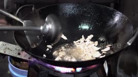 Street Vendor's Chef Cooking Fried Egg And Meat For His Fried Rice