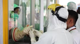 Health workers carry out COVID-19 tests in Palembang, Indonesia