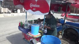 Drinks seller in Thailand has thousands of bees swarming around his cart ever day