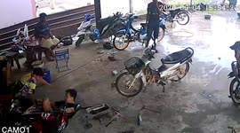 Motorcycle rider loses control and crashes while pulling into repair shop