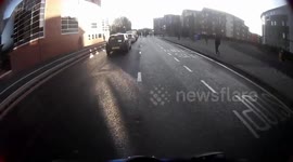 Cyclist speeds through red light and almost hits pedestrians