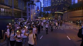 Hongkongers use cell phone lights during march marking first anniversary of anti-government movement