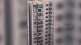 Chinese firefighters rescue girl hanging from 13th-floor window