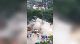 Residential building collapses into river after rainstorm in southern China