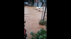 Vehicles and pedestrians struggle to navigate through flash floods in Vietnam