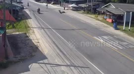 Thai motorcyclist knocked over by metal girders carried by workers crossing road