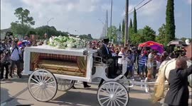 George Floyd's flower-laden casket arrives at Houston cemetery on horse-drawn carriage