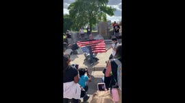 Native American Activist Stands on Toppled Christopher Columbus Statue